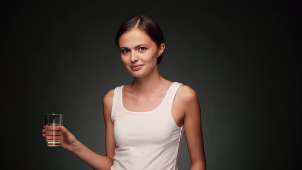 Woman in White Shirt Drinking Water