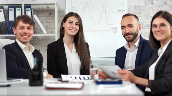 Group of Smiling Business People Wearing Suit Posing Looking at Camera in Corporate Conference