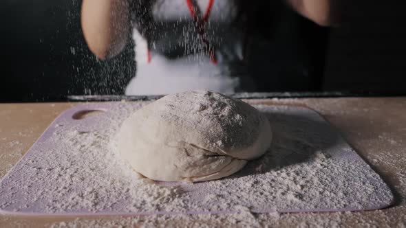 Closeup Woman Sifts Flour Through a Sieve While Baking