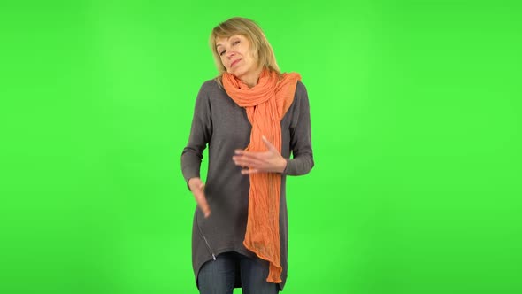 Middle Aged Blonde Woman Is Shrugging and Sighing. Green Screen
