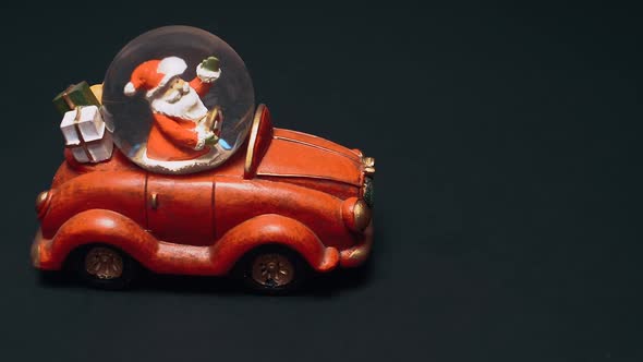Santa Claus Has Gifts for Everyone a Toy in the Form of a Red Retro Car with a Crystal in Which
