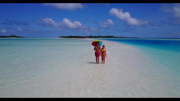 Two lovers in love on tranquil lagoon beach journey by turquoise lagoon and white sandy background o