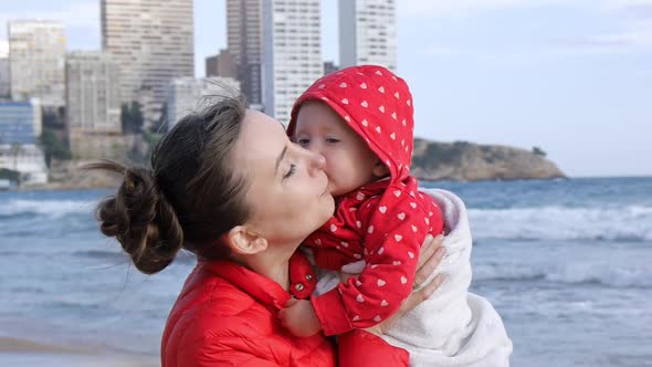 Young Mother with Baby on the Beach