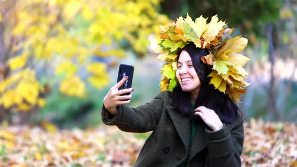 Woman Taking Selfie with Yellow Maple Leaves Wreath