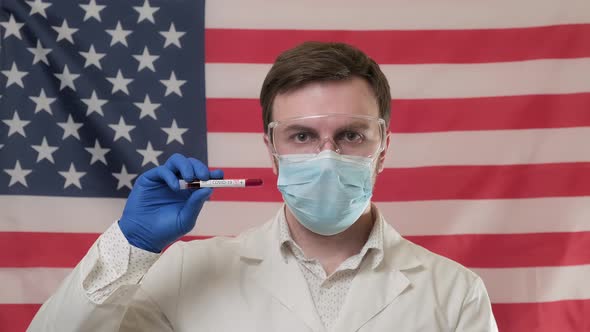 Doctor Confirming Infection of Coronavirus at USA Flag. Holding Test Tube