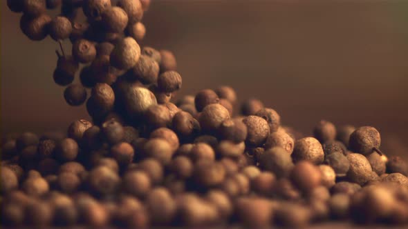 Super Slow Motion Black Pepper Peas Fall Into a Heap