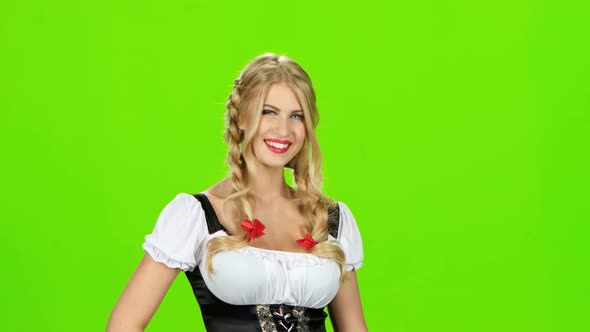 Woman in Bavarian Costume Laughs and Shows Thumbs Up. Green Screen