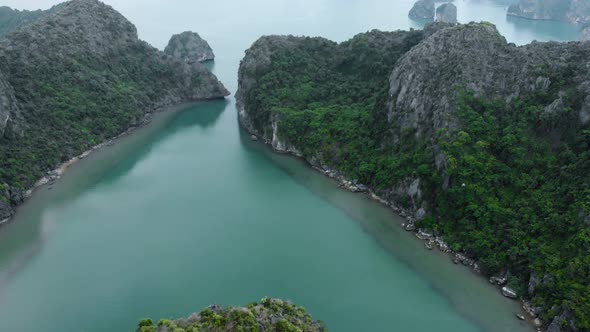 Aerial: flying over Ha Long Bay rock pinnacles, famous tourism destination in Vietnam