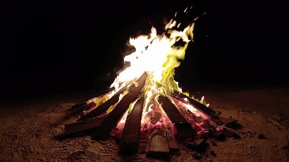 Bonfire on beach at night. Bonfire flames in slow motion.