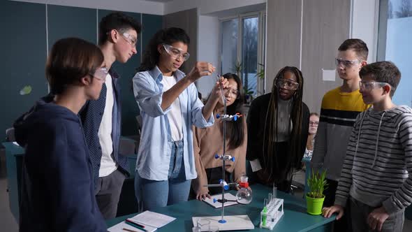 Interested Teen Pupils Observing Chemical Reaction
