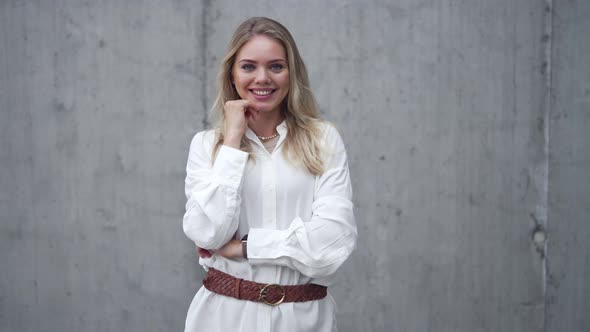 Positive Woman Standing Against Wall