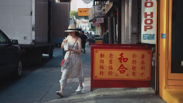 Young woman with a box of noodles