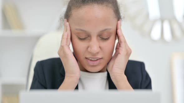 African Businesswoman with Laptop Having Headache