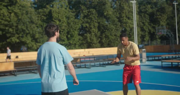 Basketball Player Does Three Point Shot Smiling Friend Greets