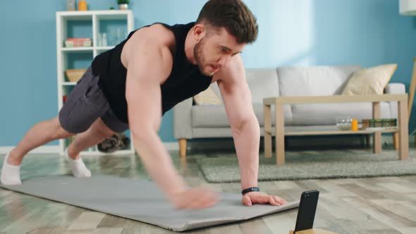 Athletic Man Practices Planks