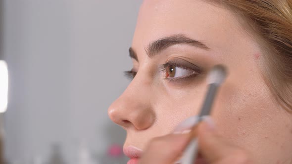 Work of a Makeup Artist. Applying Shadows To the Eyelid of the Model's Eye