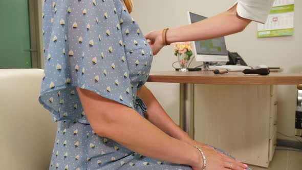 Neurologist Examines Female Patient with Needle to Test Sensibility