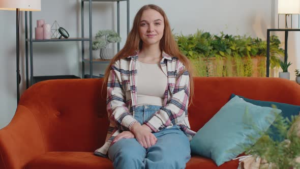 Portrait of Happy One Beautiful Teenager Student Girl Smiling Looking at Camera at Home on Sofa