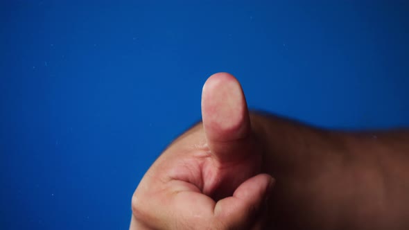 Human Hand Making Thumb Fingerprint on Blue Background