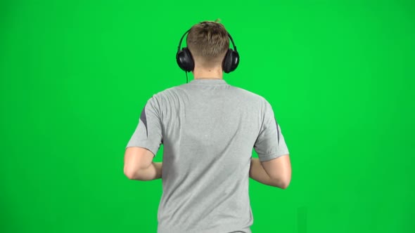 Guy in Big Headphones Is Running, Chroma Key. Back View. Slow Motion