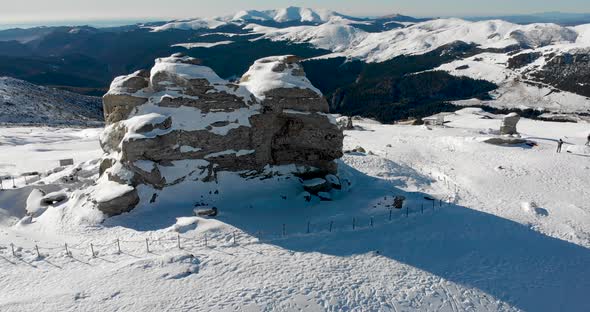 Aerial, orbit, drone shot around the sphinx rock formation, on the top of the southern Carpathians,