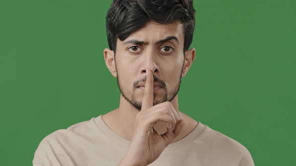 Close Up Serious Arab Guy Looking at Camera Face Young Hispanic Man Hold Index Finger Near Mouth