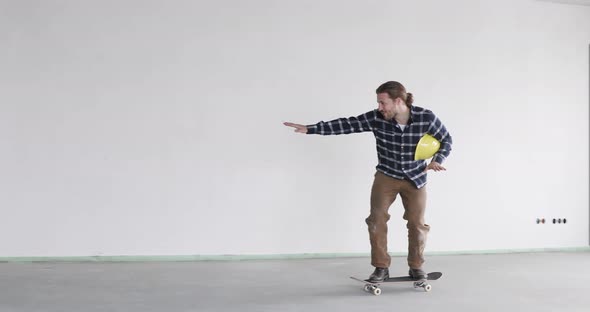 Construction worker on skateboard on construction site