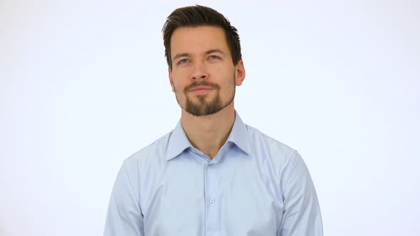 A Young Handsome Man Looks Around with a Smile - White Screen Studio