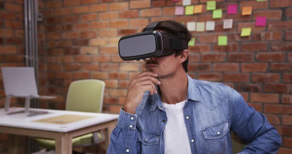 Creative businessman using virtual reality headset in modern office