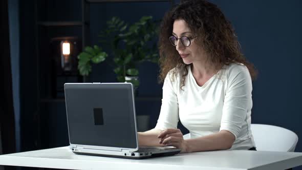 Portrait of a Beautiful Woman Working with Concentration at the Laptop