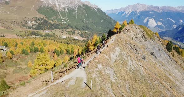 Aerial drone view of a group of mountain bikers on a singletrack trail.