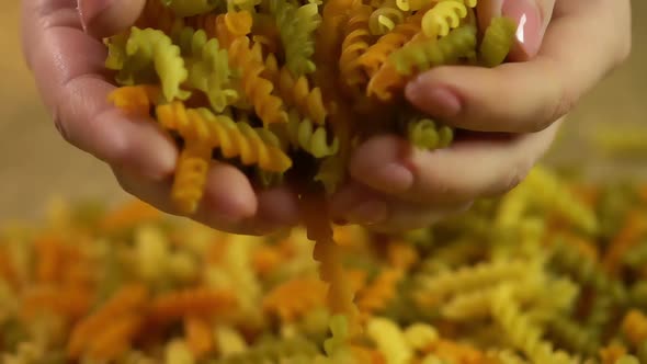 Female Seller Demonstrating Dry Colored Pasta to Buyer, Italian Kitchen