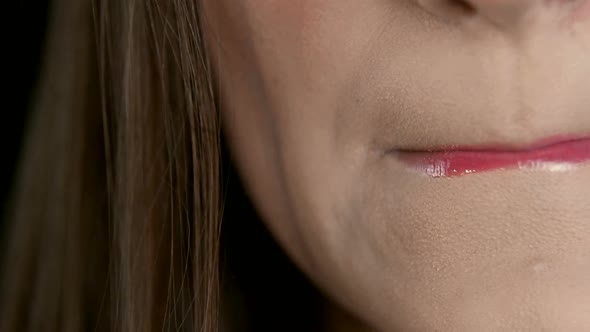 Hands of the Artist Make-up Which Draws the Girl's Lips Close-up. Bone Paints Her Lips with Red