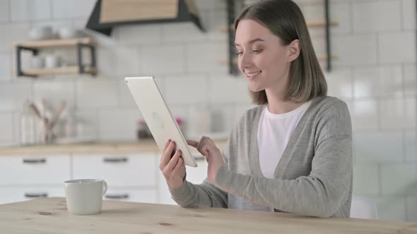 Creative Young Woman Using Tablet at Home