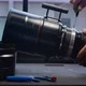 Using a screwdriver to remove screws on the barrel of a big movie camera zoom lens - VideoHive Item for Sale