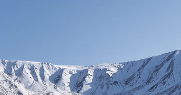 Timelapse of Sun Movement on Crystal Clear Sky Over Snow Mountain Top