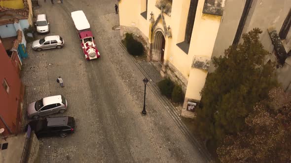 A tilt movement drone shot with orthomosaic framing, capturing an empty, fancy looking public tram w