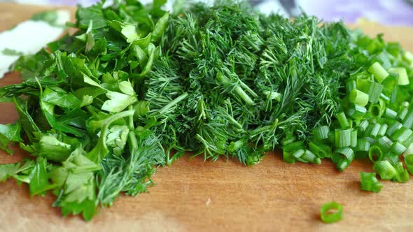 Knife, Cut Green Onion, Parsley And Dill On Brown Wooden Chopping Board