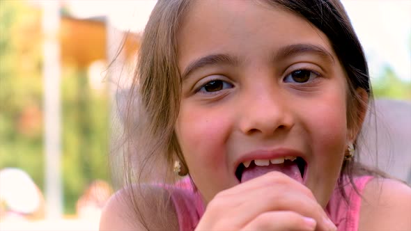 A Child Eats Ice Cream in the Park