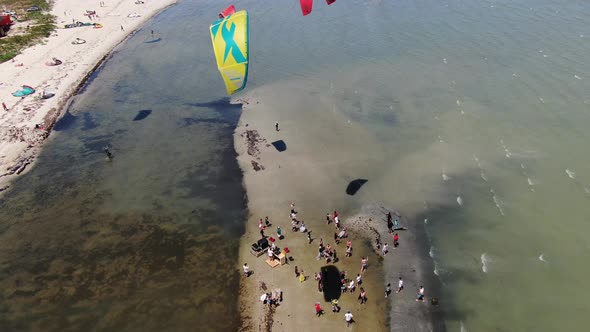 Aerial Footage of Kitesurfers and People on the Shore, Sunny Day, 