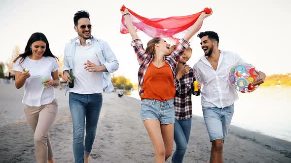 Group of Happy Friends Having Fun at Beach in Summer