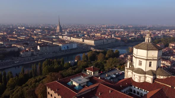 Sunset aerial over Turin, Po River and the Monte dei Cappuccini, foggy day