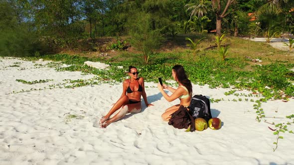 Beautiful ladies look beautiful on beautiful coast beach adventure by clear water and bright sand ba
