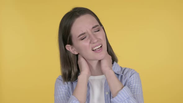Young Woman with Neck Pain, Yellow Background