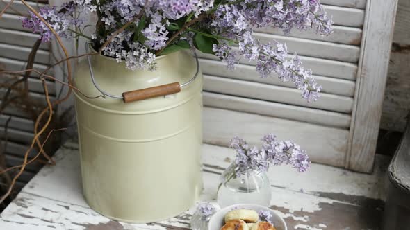 Two Bouquet of Lilac Flowers in Zinc Pots on a White Wooden Board Home Decor in a Rustic Style