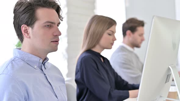 Serious Creative Team Looking at the Camera in Office