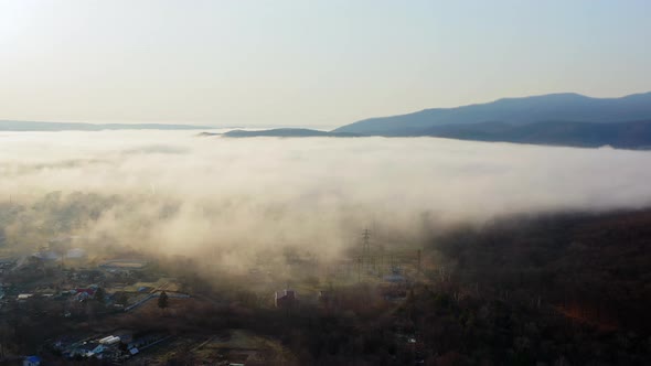 Flight Over the Valley Covered with Morning Mist in the Countryside