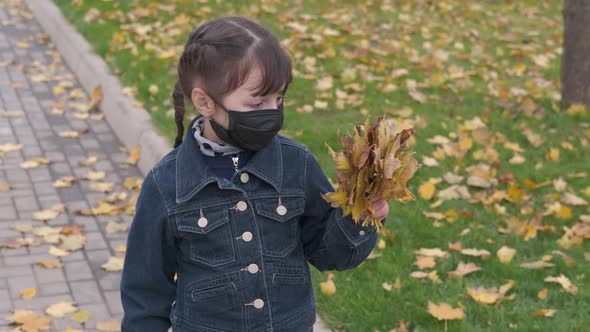 Masked child in autumn.