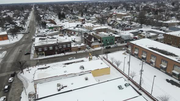 Aerial view in winter of older rural community neighborhood with construction working going on.