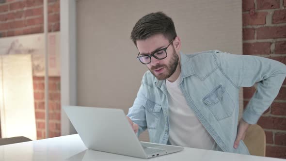 Tired Young Male Designer Having Back Pain